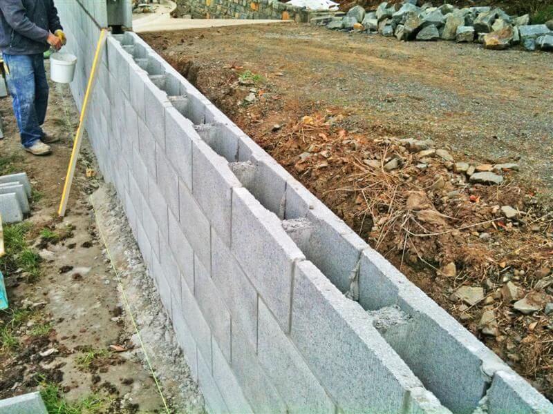Reinforced block retaining wall