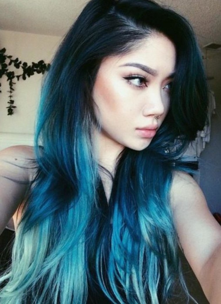Girl taking a selfie in profile, showing her electric blue hair and aqua