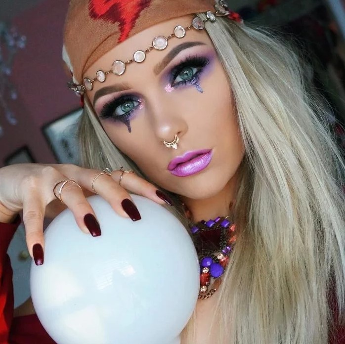 Blond woman dressed as gypsy with crystal ball
