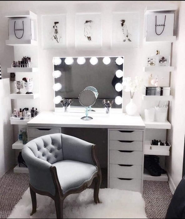 White dressing table with spotlights and a sofa
