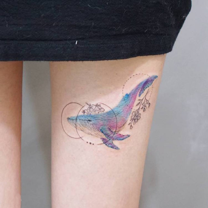 Girl with a whale tattoo on her leg