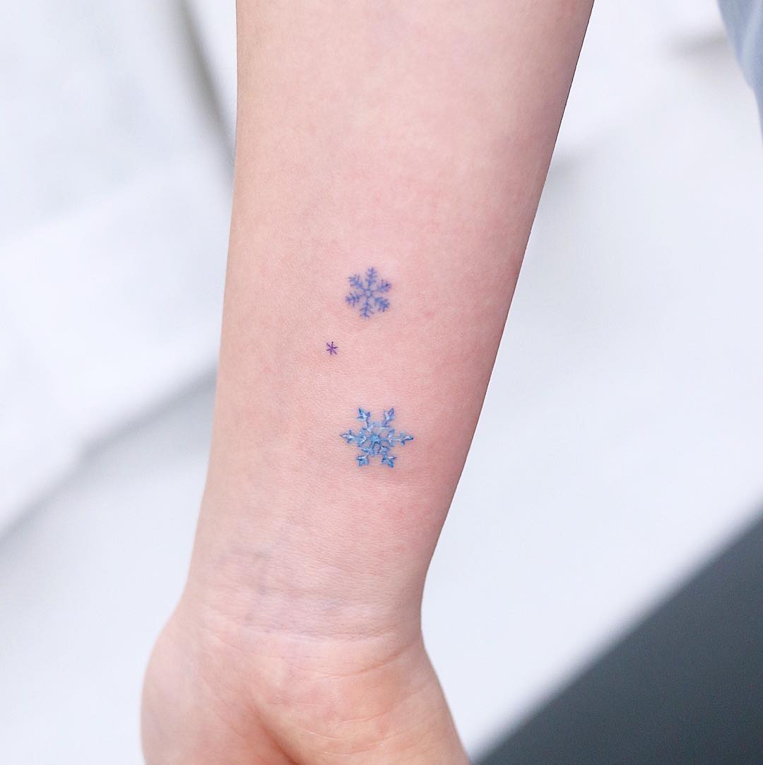 Girl with a tattoo of snowflakes