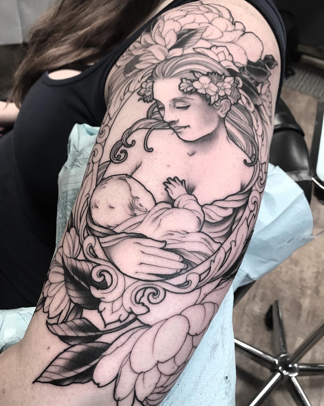 Tattoo of a mother carrying her child