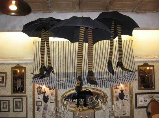 Hanging umbrellas with witch's feet.