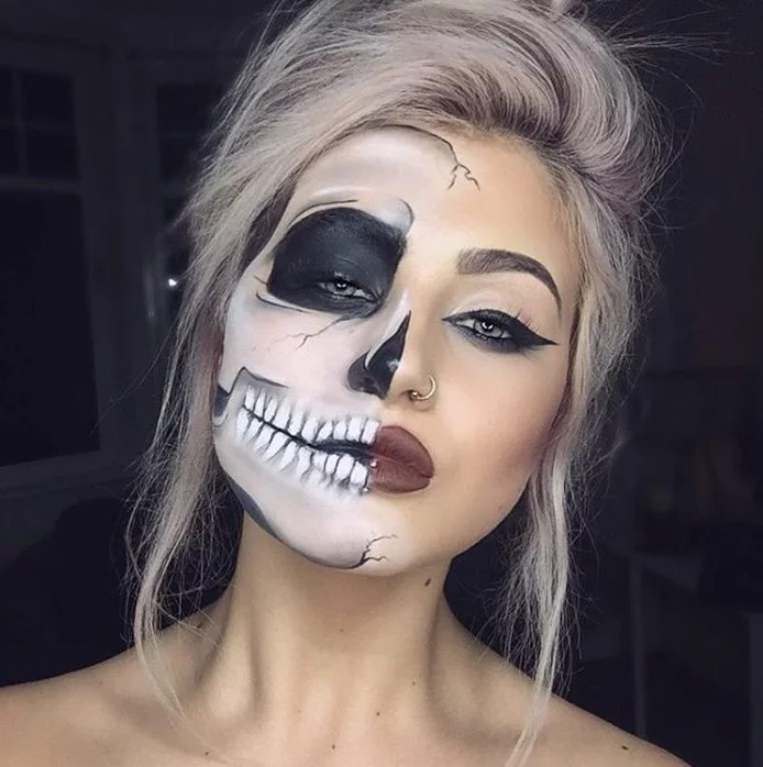 Blond woman with half her face painted skeleton